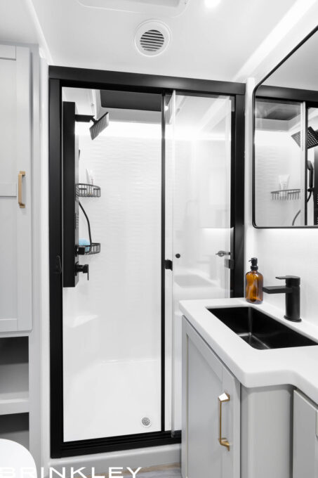 Modern large and tall 42x30 inch one-piece molded fiberglass shower unit inside a Brinkley RV Model Z Fifth Wheel with neon COB LED lighting.