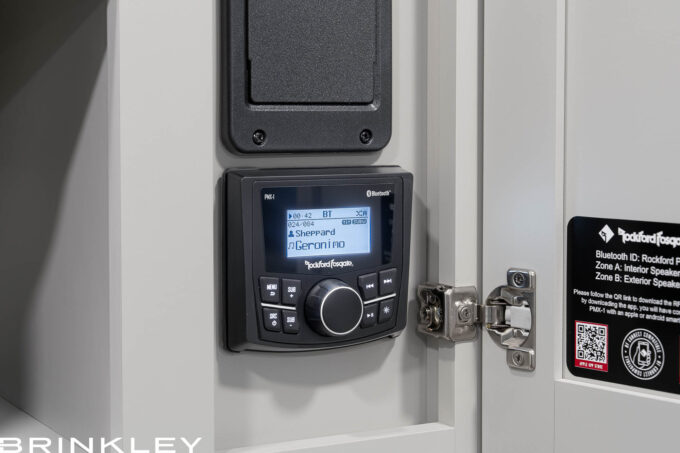 Rockford Fosgate premium audio system control panel mounted in a Brinkley Model Z luxury Fifth Wheel, featuring Bluetooth connectivity and app-based control for indoor and outdoor entertainment.
