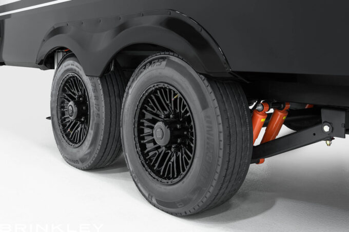 Close-up of premium high-capacity RV tires and aluminum wheels on a luxury Brinkley RV Model Z Fifth Wheel