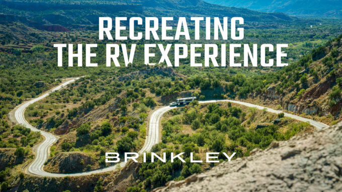 RVing towing a luxury Brinley RV Model G fifth wheel toy hauler down a windy road showcasing a high quality RV Engineered to a Higher Standard that's Recreating The RV Experience.