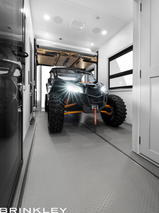 Interior view of massive 17-foot fifth wheel toy hauler RV garage and flex space converted for office or living use.
