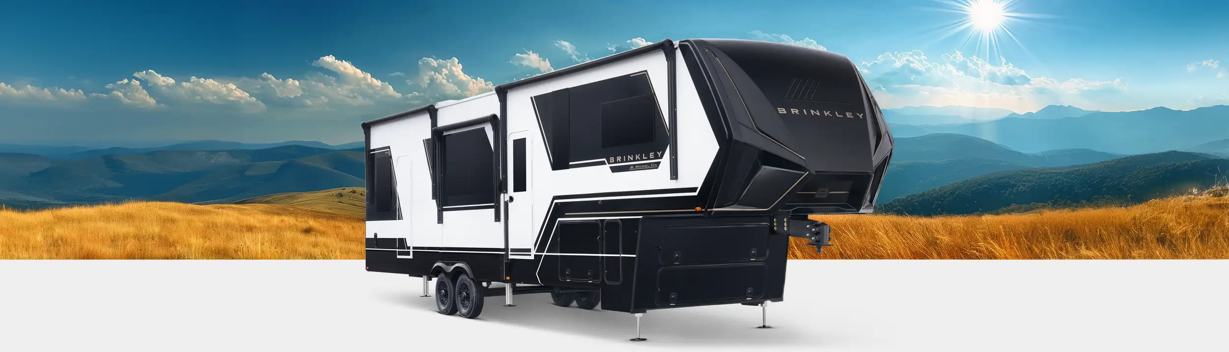 Sleek exterior profile of the Brinkley RV Model Gx Luxury Fifth Wheel Toy Hauler featuring automotive-grade graphics and a spacious rear garage for outdoor equipment