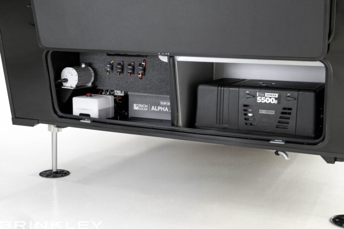 Brinkley RV Model Gx fifth wheel toy hauler's basement storage and energy system featuring a FlexPower 5500 EFI generator and 200 Ah lithium battery bank.