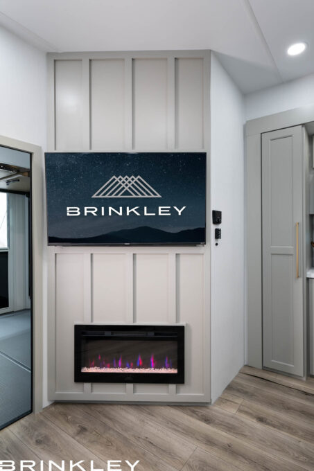 For the TV & Entertainment Wall image (Model-Gx-3500x-Fifth-Wheels-Living-Room-TV-Entertainment-Wall-2026-Brinkley-RV-0559.jpg) you currently have selected in the WordPress media library, here are a few alt text options:

Option 1: Descriptive & SEO-Rich (Recommended)
"Interior view of the Brinkley Model Gx entertainment center featuring a 50-inch Smart 4K UHD TV on a swivel mount above a built-in 5,000-BTU electric fireplace.