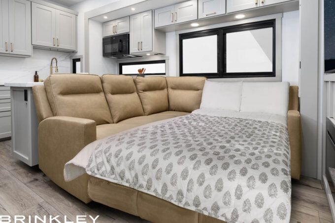 | Model G 3250 Toy Haulers 40 Model Gx living room L-Sofa converted to optional EZ-Out Bed sleeper in a luxury toy hauler