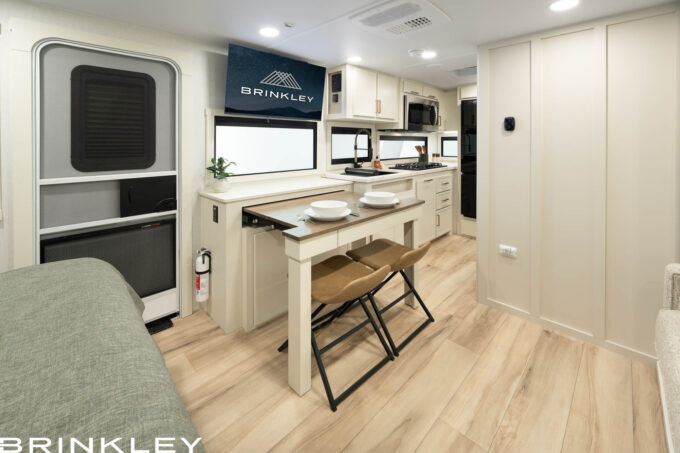 pull-out dining table expanded with an integrated utensil storage drawer