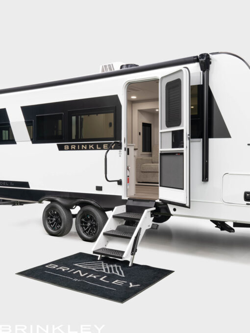 Brinkley RV Model Ix 20x exterior entry featuring solid aluminum steps and a large 28-inch door with integrated window shade.