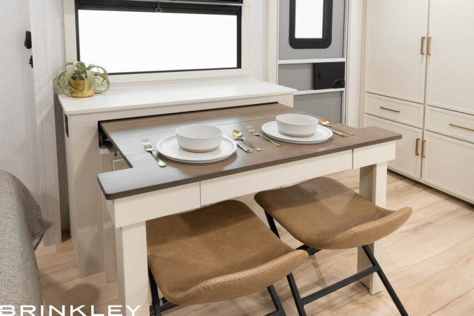 pull-out dining table expanded to seat four with an integrated utensil storage drawer