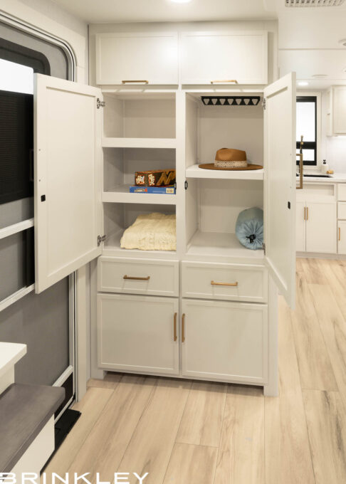 Detail view of the floor-to-ceiling storage closet in the entryway of a Brinkley Model Ix 23x travel trailer