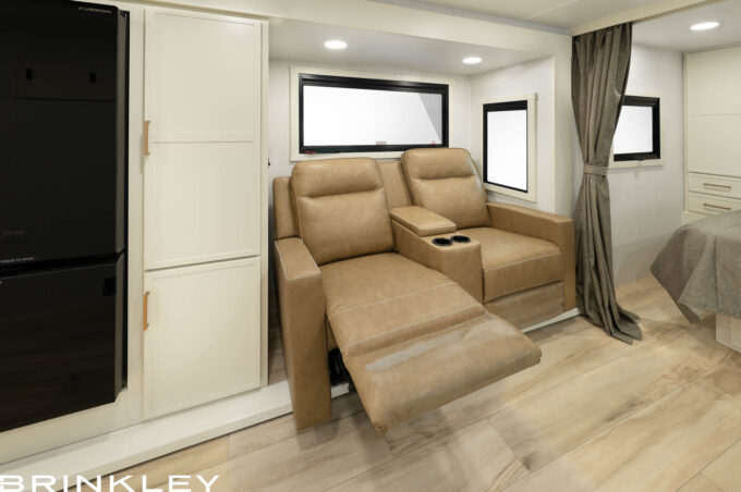 Luxury wall-hugger theater recliners in the living area of a 23x travel trailer