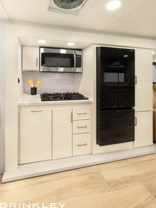 High-capacity 12-volt refrigerator and convection microwave in a Brinkley Model Ix 23x luxury travel trailer floorplan