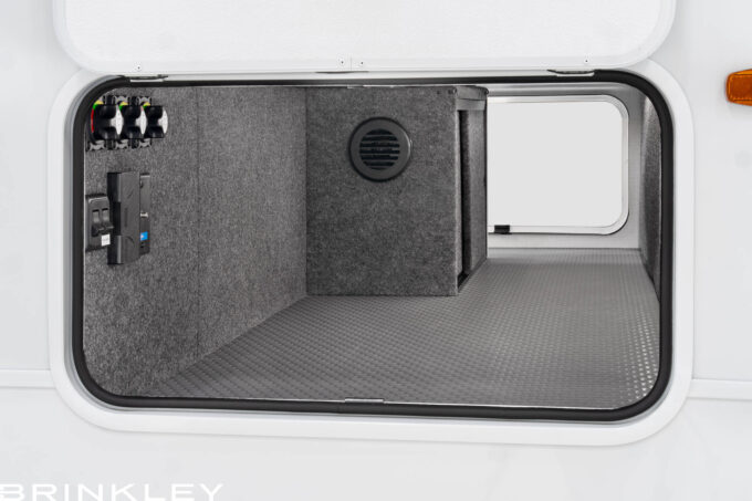 Brinkley RV Model Ix 24x large pass-through storage featuring forced-air heat, insulated slam-latch doors, and anti-skid Tough-Ply flooring